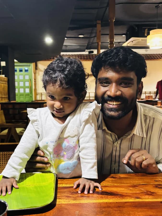 Daniel and Lael at a restaurant table, both smiling